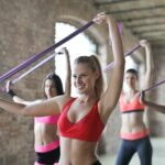 A featured image showing fitness enthusiasts with resistance band training. This post by Healthy and Better Living talks about band training for fitness enthusiasts