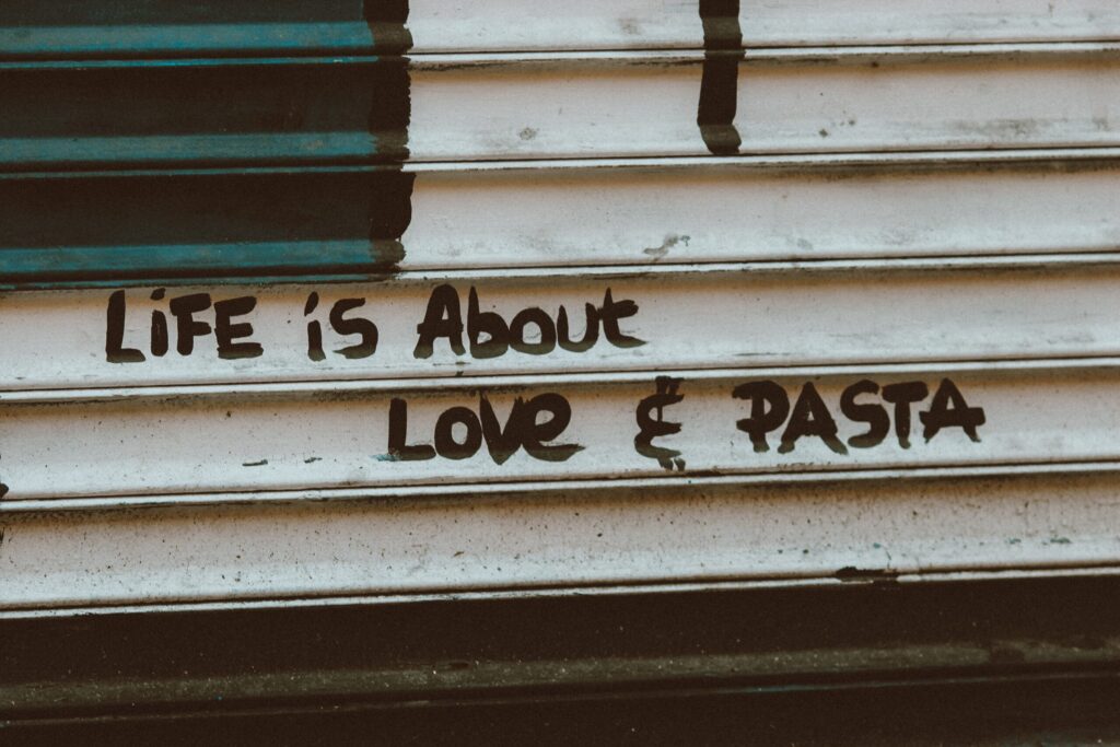 A shop shutter with message on life is about love and pasta, - The Most Delicious and Easy Pasta Recipes: A Mouth-Watering Guide on Healthy and Better living Website