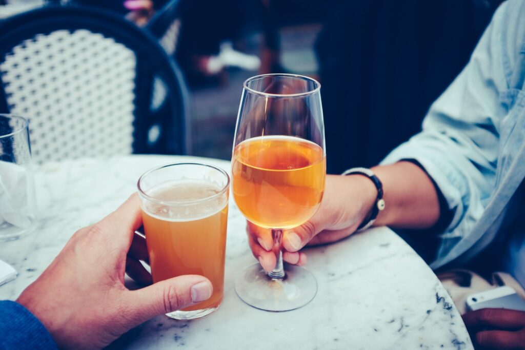 Having a toast of beer and wine in the article of the 10 Most Underrated Beers and Wines on the healthy and better living website