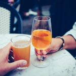 Having a toast of beer and wine in the article of the 10 Most Underrated Beers and Wines on the healthy and better living website