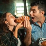 featured image of couple eating street food in the article on the most famous street foods published on healthy and better living