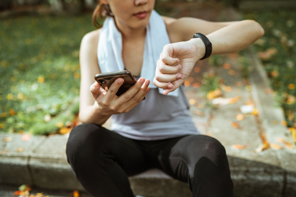image of a girl wearing a smart health watch and checking stats on Healthy and better Living website 