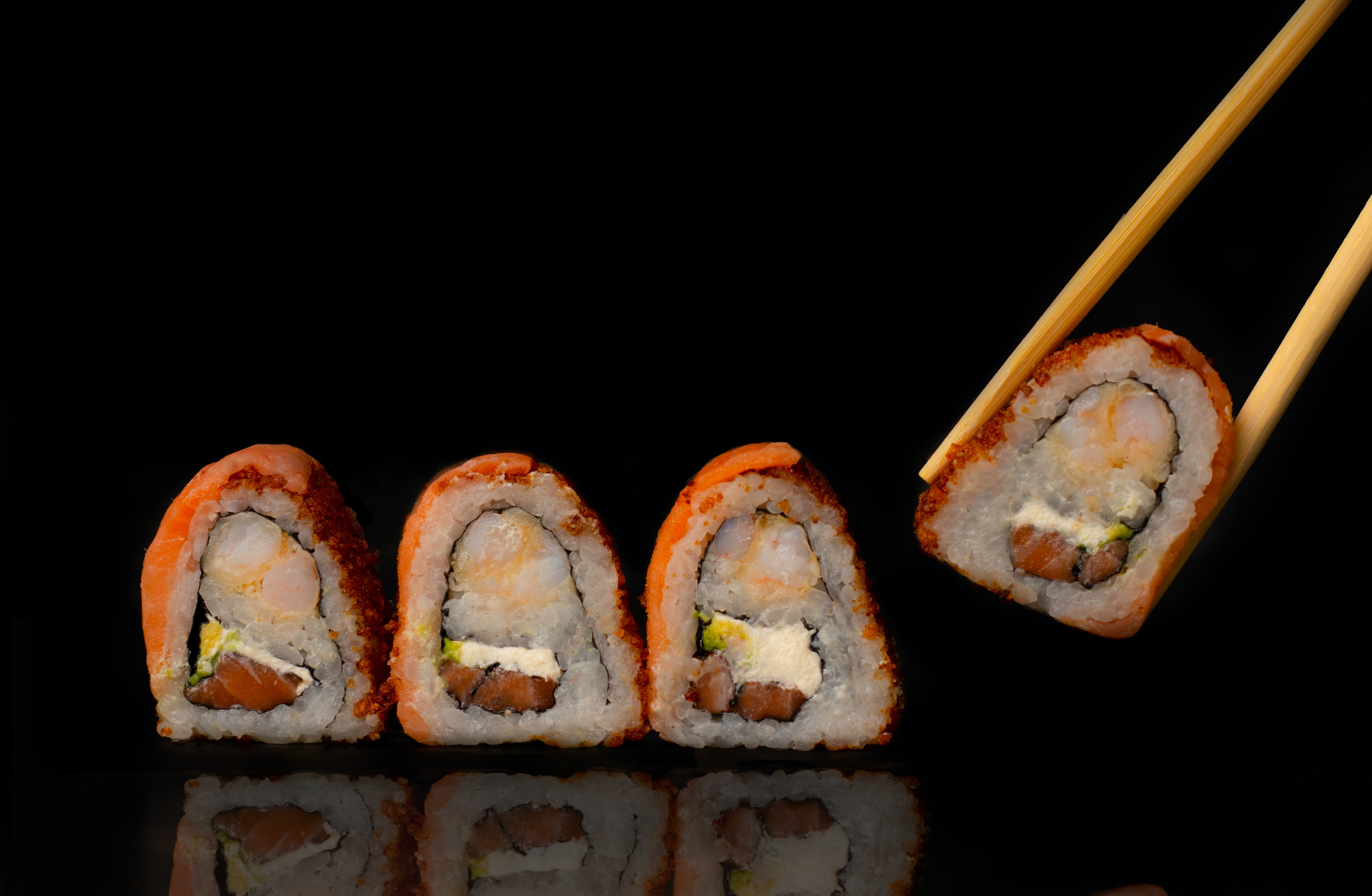 history and cultural significance of sushi - picking sushi with chopsticks - Healthy and better living