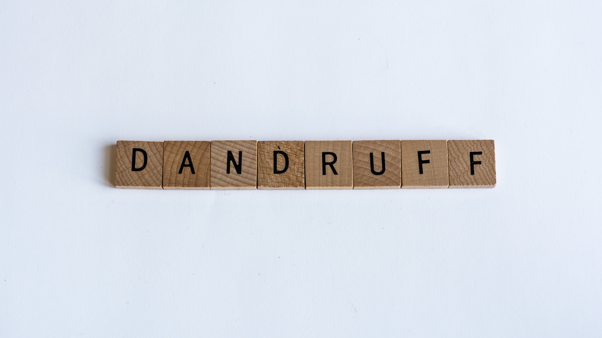 Dandruff written on blocks featured on Big Dandruff Flakes published on healthy n better living