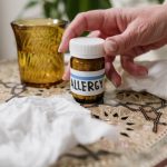 Featured image of a person about to take a medicine featured in the article - Achoo, No More! Navigating Common Allergies with Ease